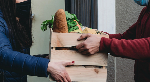 food bank handing a box of food to a person